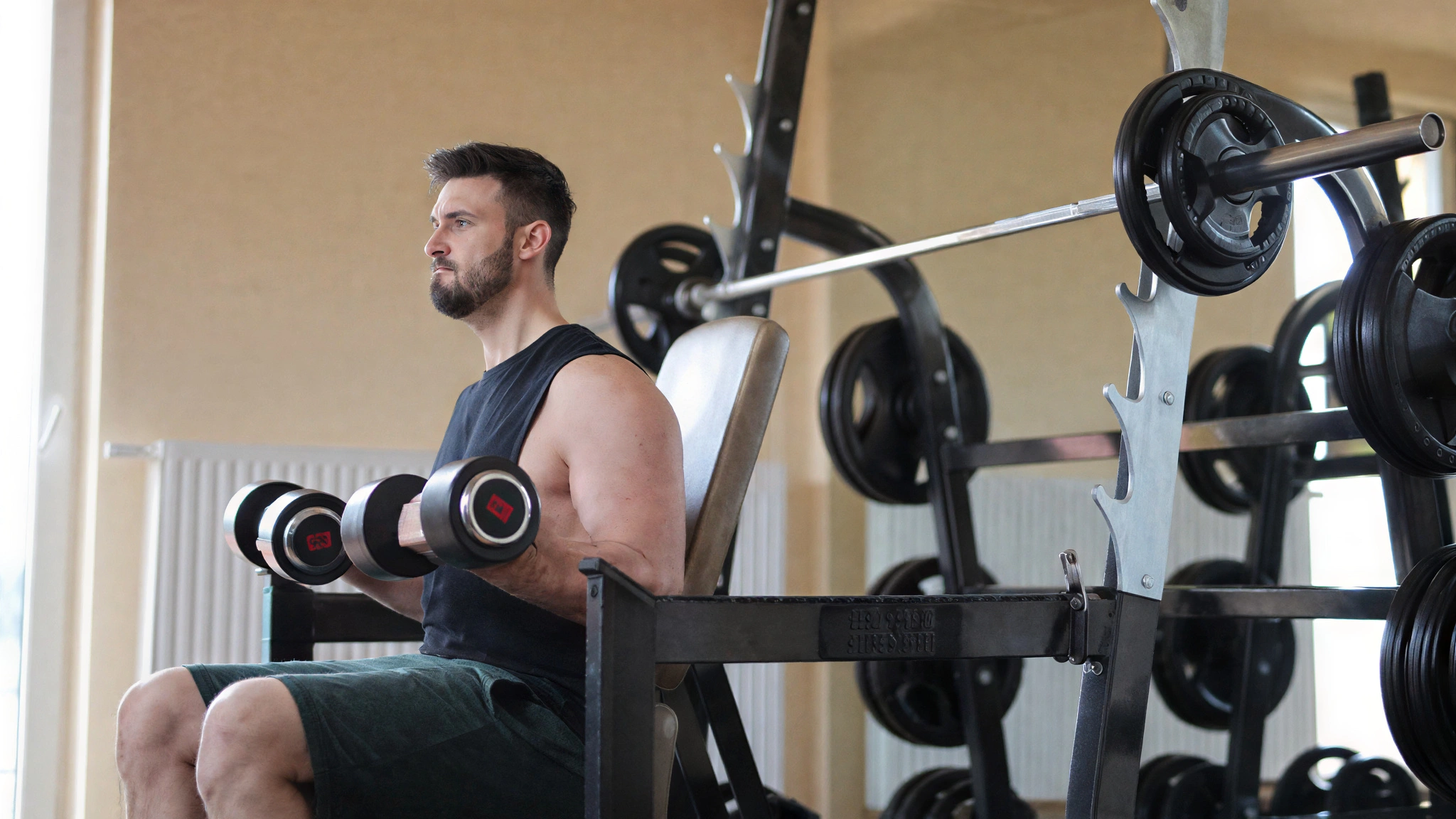 Man performing strength training with dumbbells in a gym